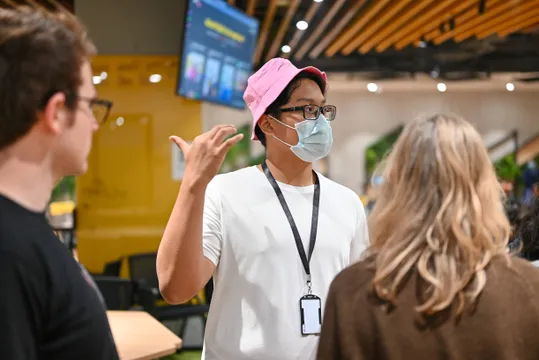 A person standing in between two other people looking to the side.